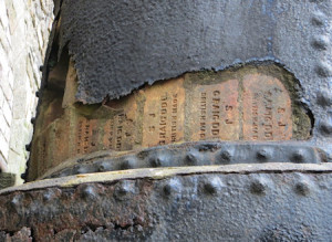 The manufacturers names carved into the bricks lining one of the ruined chimneys