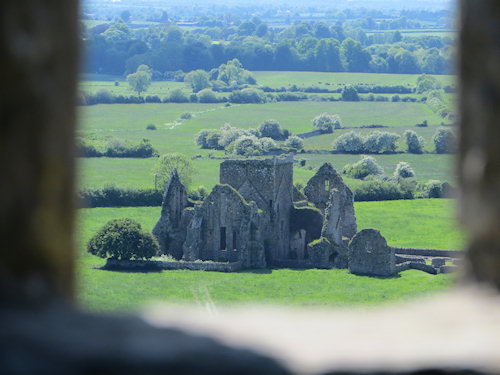 Looking through the window of a ruined castle toward a nearby church - also in ruins. My imagination was running wild.