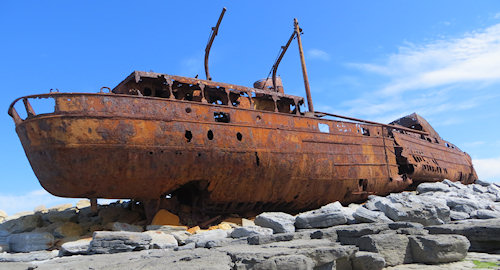 The ship originally ran aground on rocks near the island, but another storm pushed her up on shore several weeks later. Since then, she has been pushed around by several storms, as she lies rioting on the rocky shore.